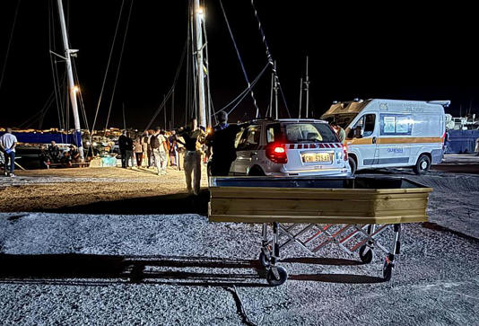 In this photo provided by RESQSHIP, a coffin on the dock of the Sicilian island of Lampedusa, early Saturday, 23 August 2025. AP Photo