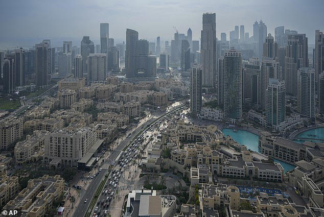 Vehicles are driven along a road with Dubai's iconic skyline in the background last December&nbsp;