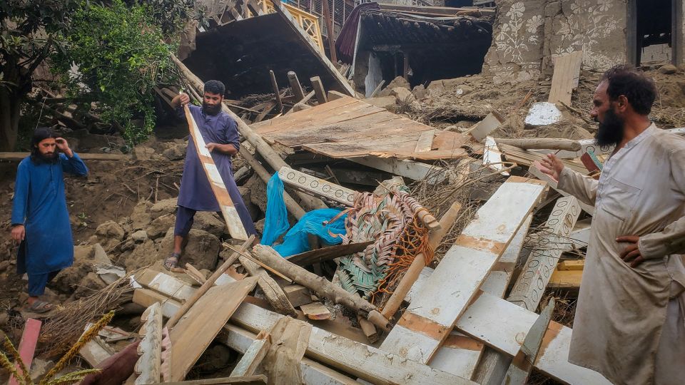 Afghan men search amidst the rubble of a collapsed house after a deadly earthquake in Kunar province, Afghanistan, on Monday. - Reuters