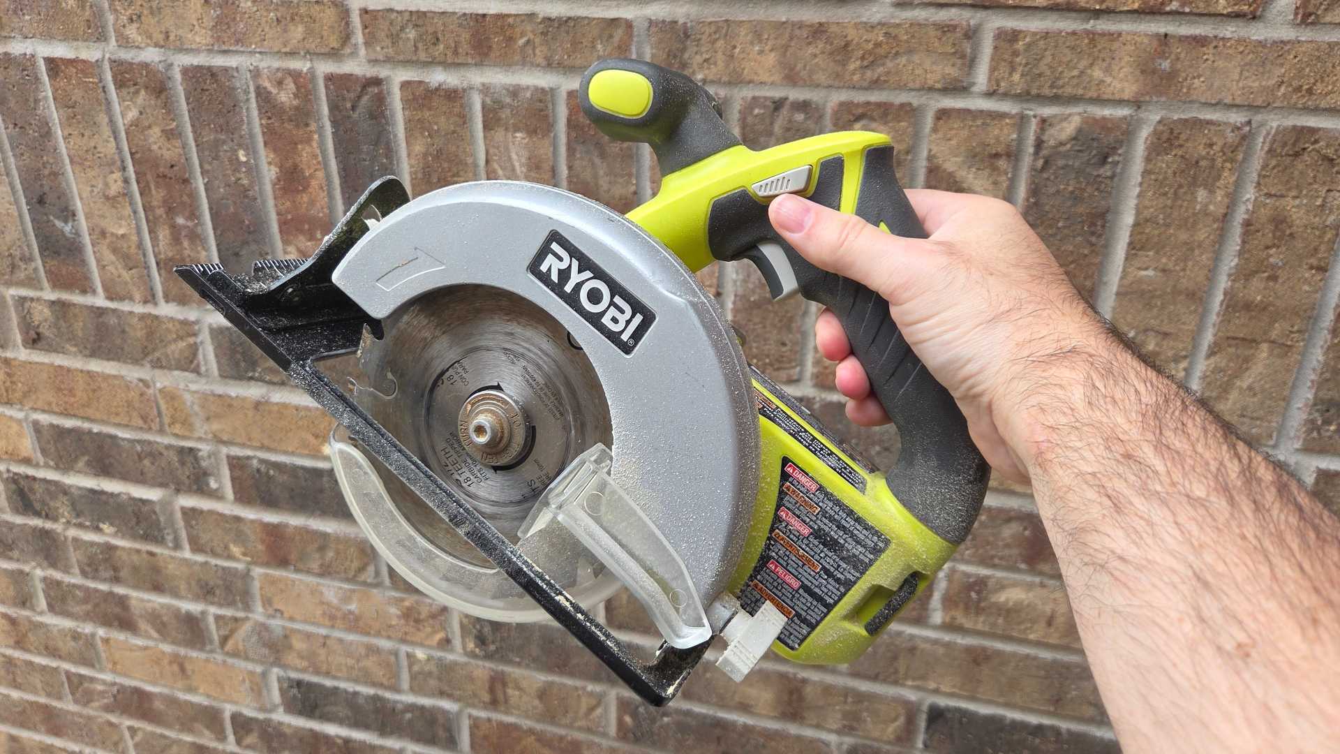 Man holding a Ryobi Circular Saw.