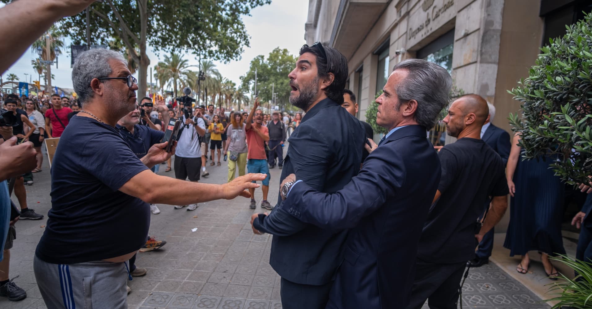 A man argues with protesters outside a Barcelona hotel on July 6, 2024.