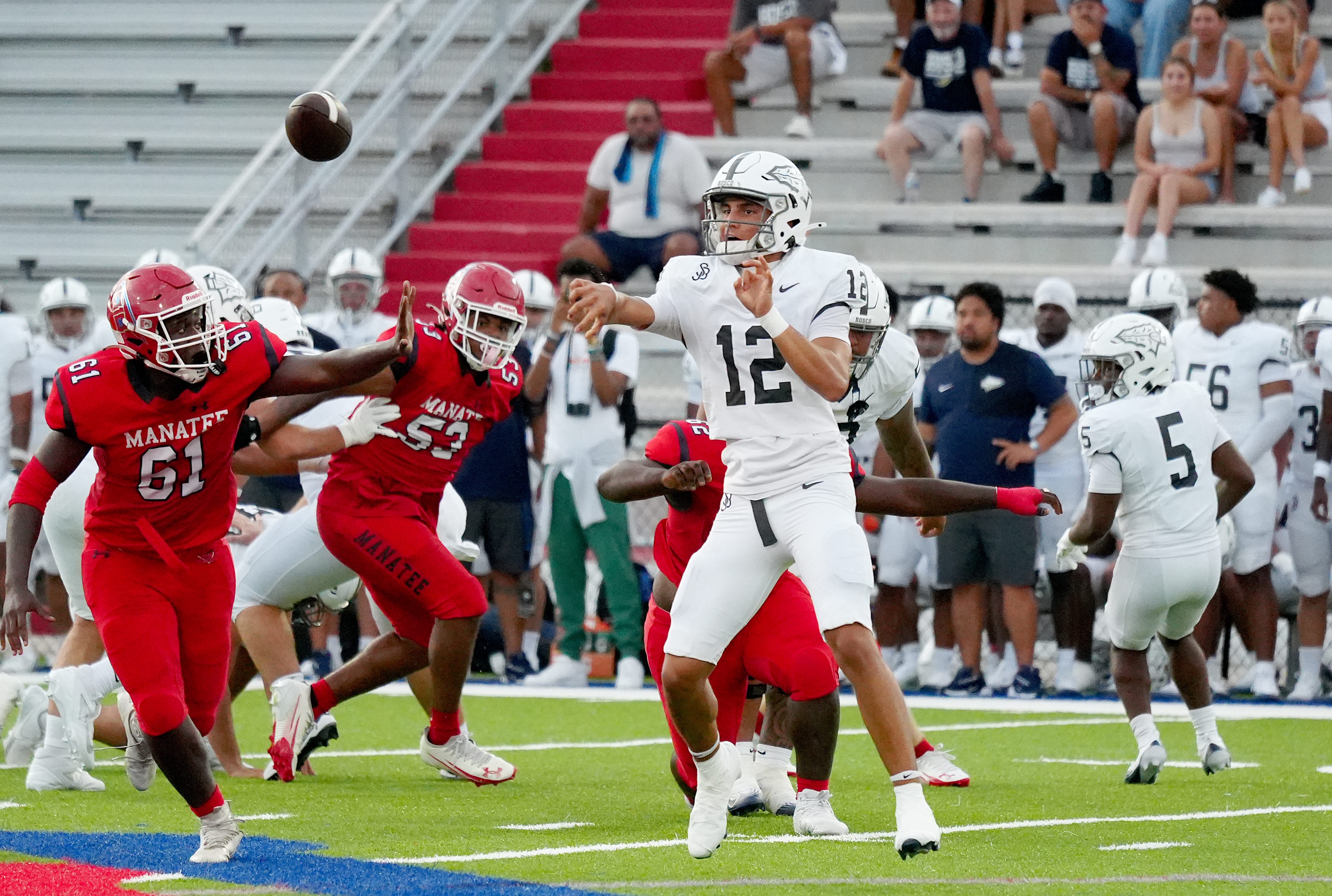 Bosco's quarterback Koa Malau'ulu (#12). The Manatee Hurricanes hosted St. John Bosco (California) with a 31-0 lead over Manatee at halftime. After a long lightning delay the rest of the game was canceled at Joe Kinnan Field at Hawkins Stadium on Friday August 22, 2025, in Bradenton, Florida.