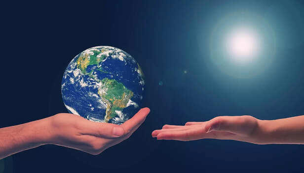 Hands holding the Earth, symbolizing sustainability and responsibility.
