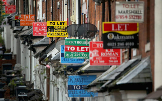 An array of To Let and For Sale signs protrude from houses in the Selly Oak area of Birmingham