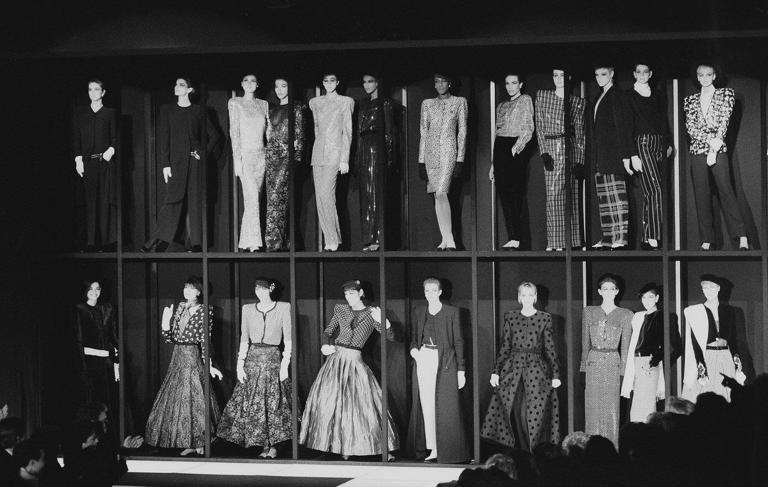 FILE - Models presenting the Giorgio Armani fashion collection stand in showcases at the end of the showing for Fall-Winter 1985-86 in Milan, March 13, 1985. (AP Photo/Ferdinando Meazza, file)