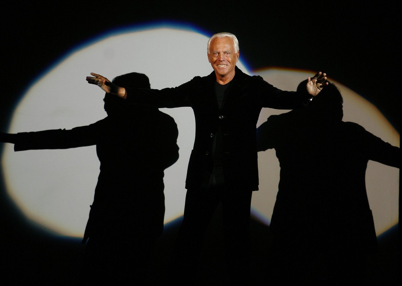 FILE - Giorgio Armani receives his share of applause after presenting his Emporio Fall-Winter 2007-2008 men's fashion collection, during the Milan Men's Fashion Week, in Milan, Italy, Monday, Jan. 15, 2007. (AP Photo/Luca Bruno, File)