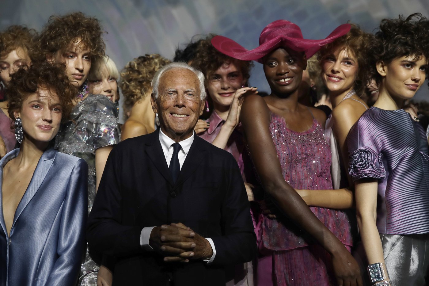 FILE - Designer Giorgio Armani, centre, poses with models at the end of his women's 2019 Spring-Summer collection, unveiled during the Fashion Week in Milan, Italy, Sunday, Sept. 23, 2018. (AP Photo/Luca Bruno, File)