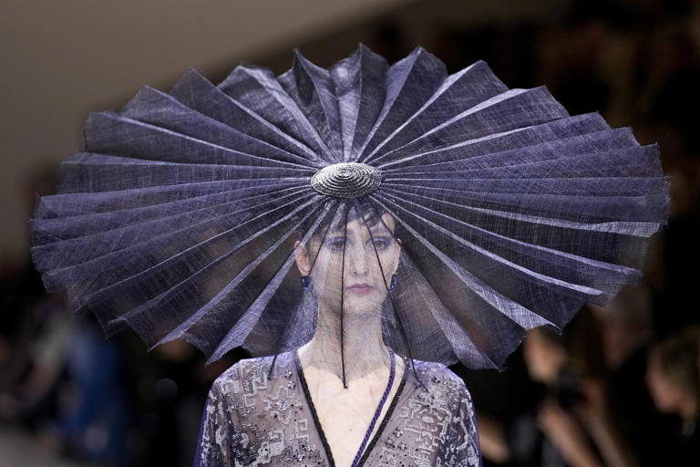 FILE - A model wears a creation for Giorgio Armani Prive as part of the Haute Couture Spring-Summer 2024 collection presented in Paris, Jan. 23, 2024. (AP Photo/Christophe Ena, file)