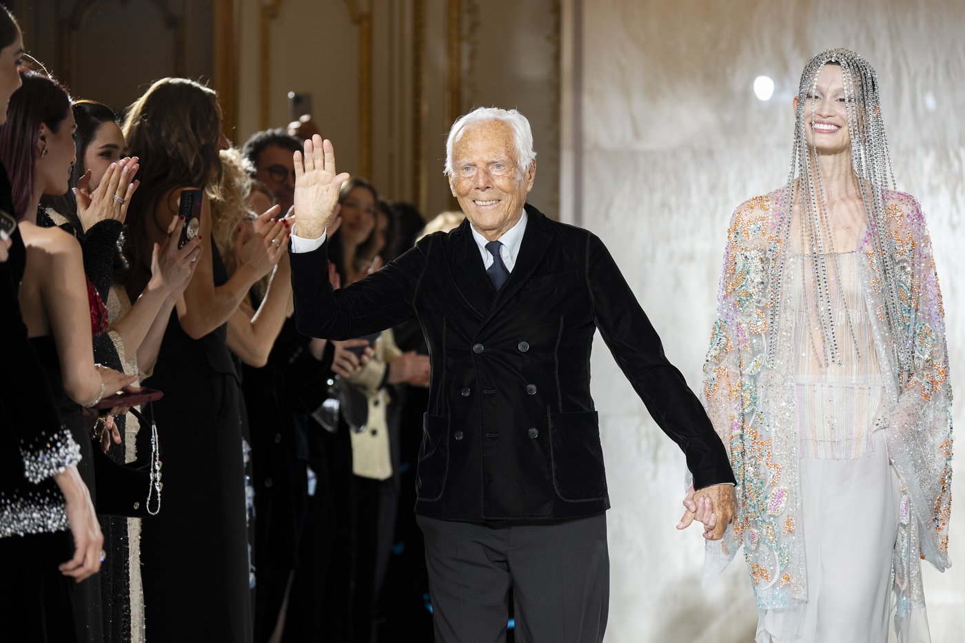 FILE - Giorgio Armani waves at the end of the Giorgio Armani Prive Haute Couture Spring Summer 2025 collection in Paris, Jan. 28, 2025. (AP Photo/Lewis Joly, File)