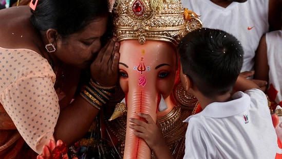 Devotees pray to an idol of Lord Ganesh, the deity of prosperity, during the ten-day-long Ganesh Chaturthi festival in Mumbai on September 2, 2025.