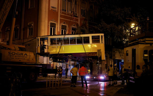Emergency workers remove one of the funiculars after the crash - Pedro Nunes/REUTERS