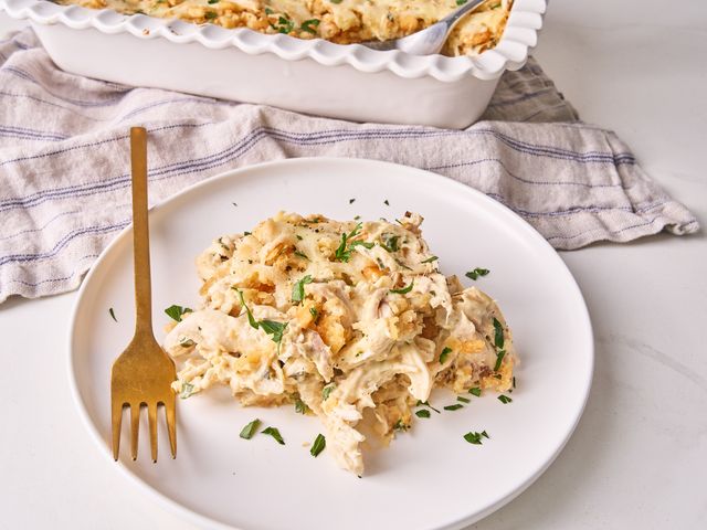 Million Dollar Chicken Casserole on a plate next to a baking dish