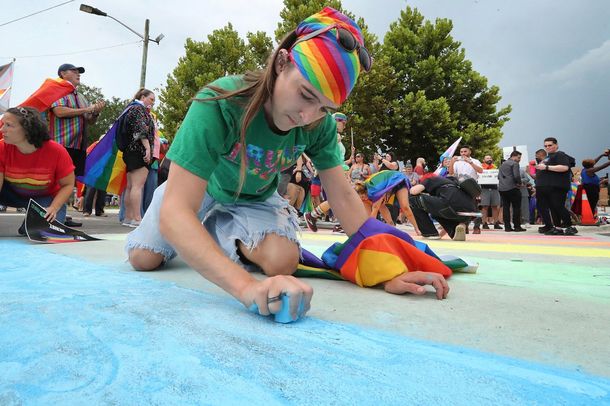 Advocates use chalk to color in rainbow crosswalk near Pulse