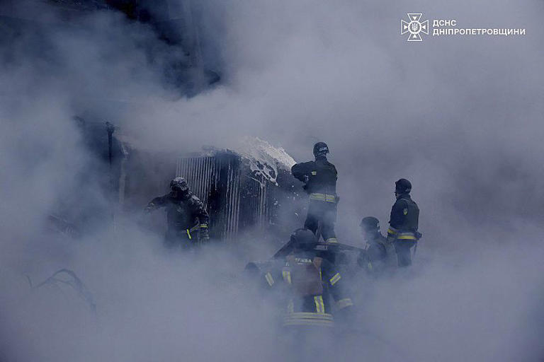 Firefighters put out a fire following a Russian missile attack on the country's energy system in Dnipropetrovsk region, 25 December, 2024 AP Photo