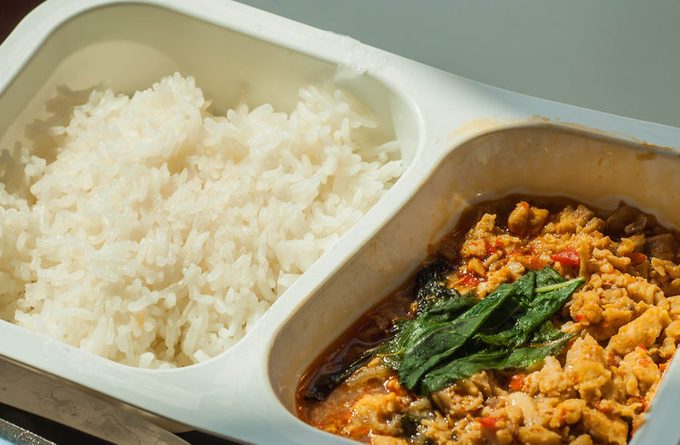 traditional thai food named pad kra pao in frozen food container