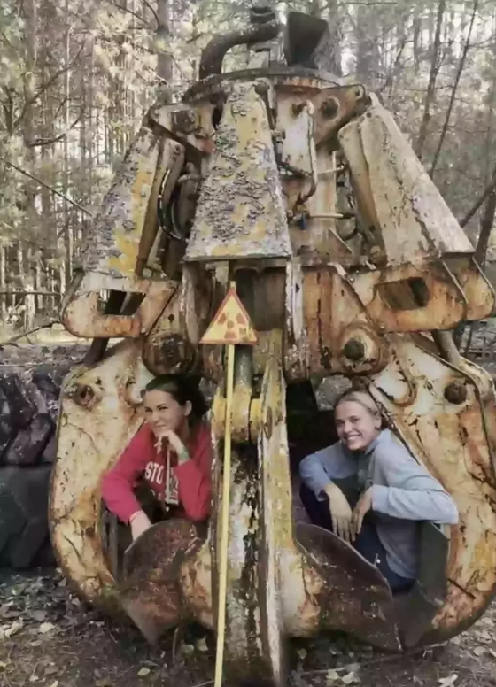 Truth behind chilling photo of women sitting on radioactive claw at ...
