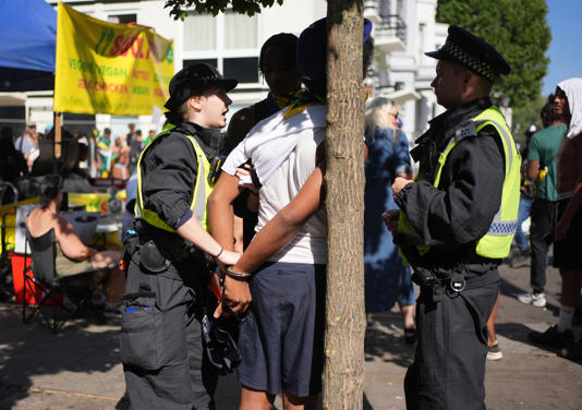 Police handcuff a man at the carnival (Yui Mok/PA Wire)