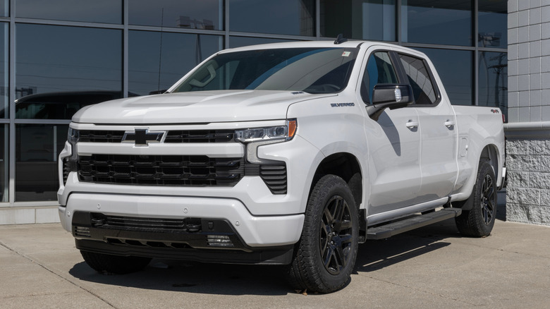 A white Silverado 1500 parked on a lot on a sunny day