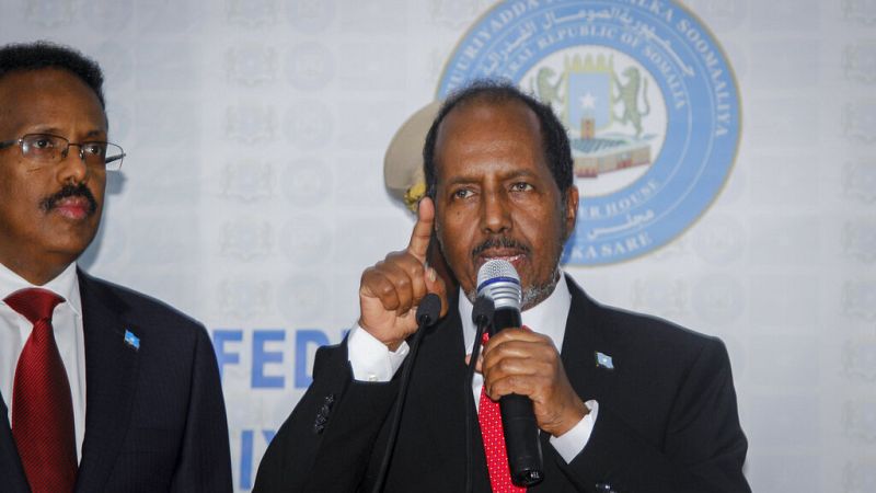 Hassan Sheikh Mohamud, right, speaks after his election victory alongside outgoing leader Mohamed Abdullahi Mohamed at the Halane military camp in Mogadishu, Somalia