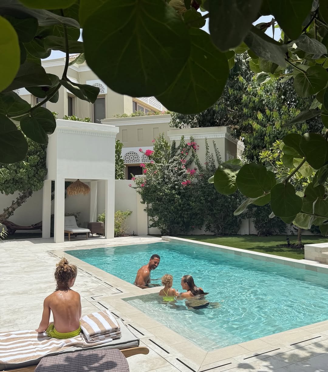 Rio and Kate Ferdinand with two of their children in the outdoor pool at their new home in Dubai