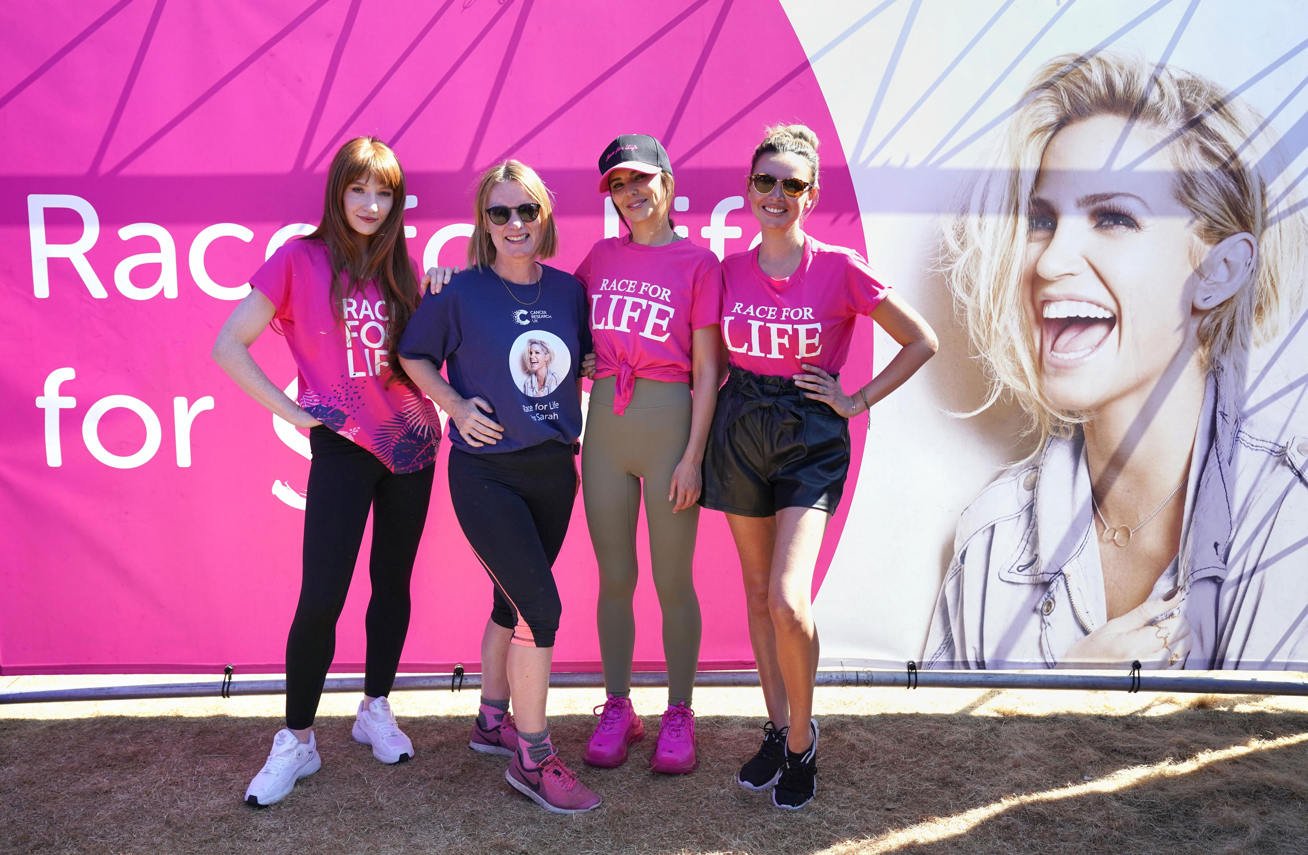 Michelle Mitchell, the chief executive of Cancer Research with Girls Aloud band members at a Race for Life event (PA Wire)