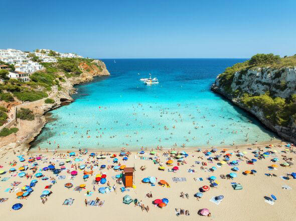 Aerial view of colorful umbrellas on sandy beach
