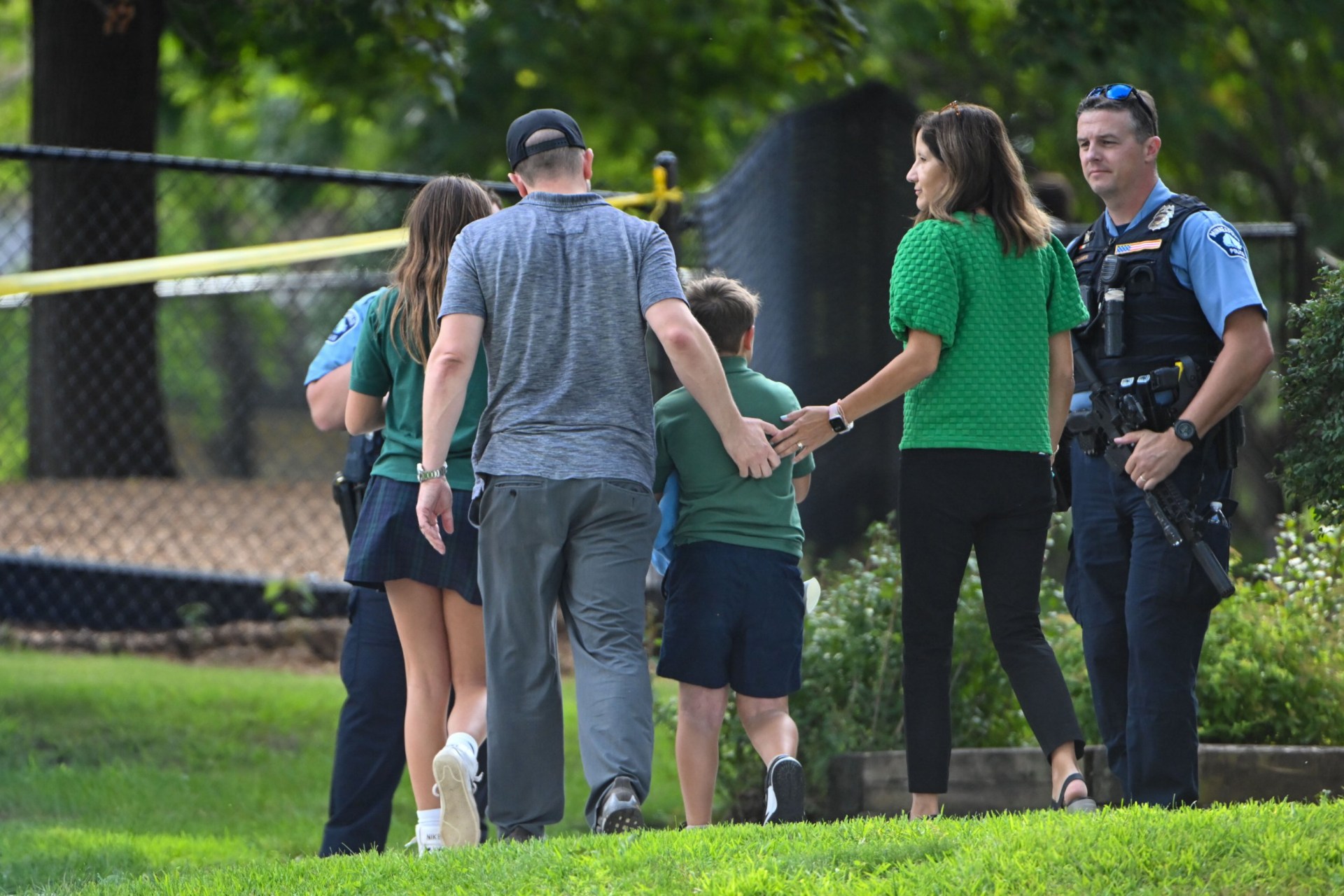 Children in their green uniforms leave the school (Picture: EPA)