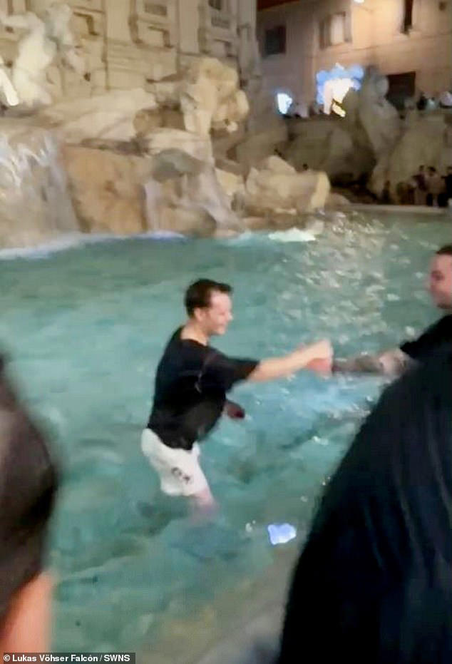 Moment idiot tourist is led away by Italian police after jumping into(02)