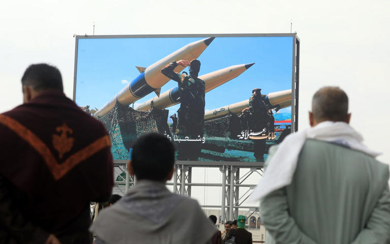 Houthi fighters next to their missiles appear on a billboard in Sanaa - YAHYA ARHAB/EPA/Shutterstock