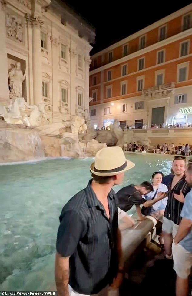 Moment idiot tourist is led away by Italian police after jumping into