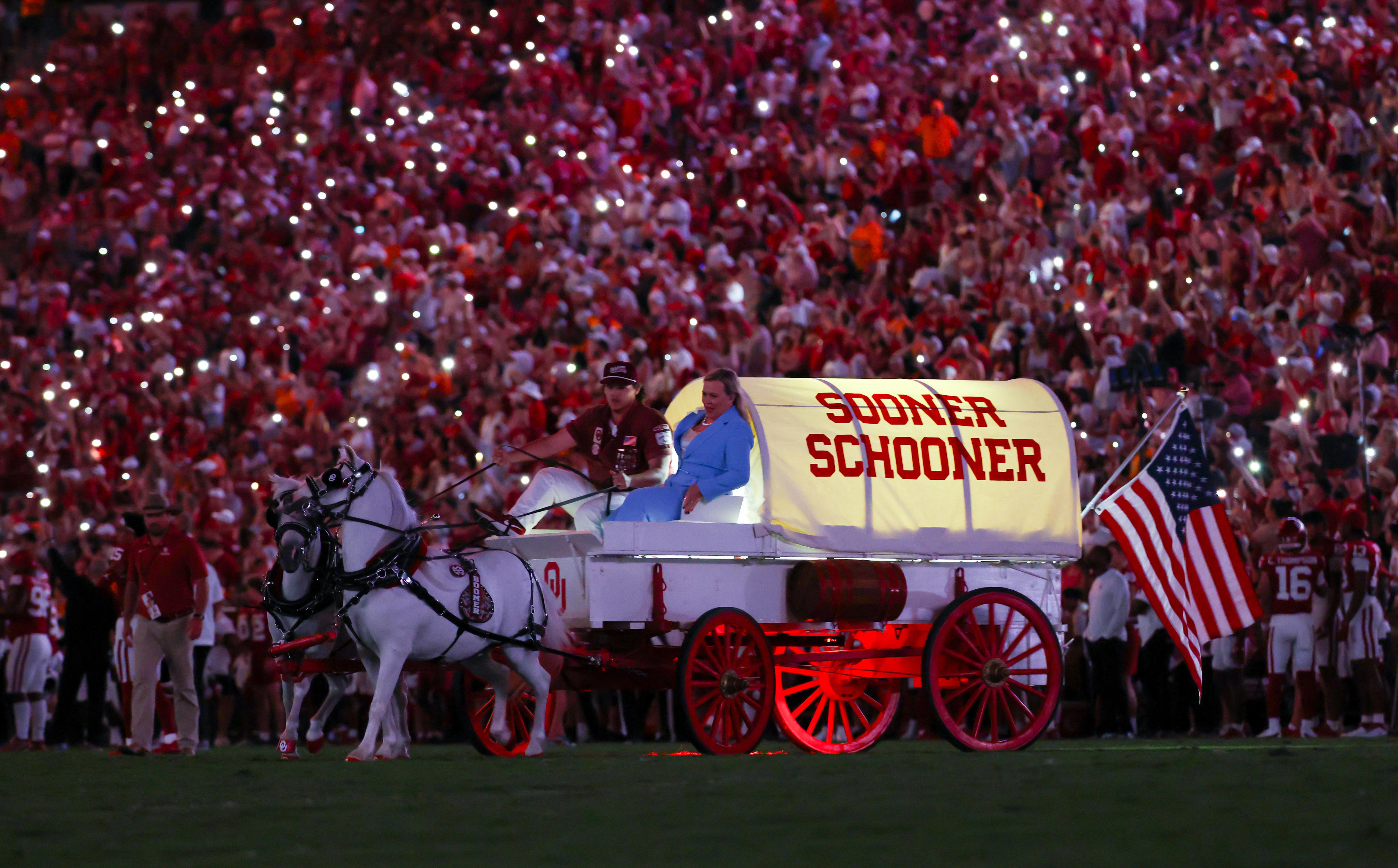 Sep 21, 2024; Norman, Oklahoma, USA; ESPN commentator Holly Rowe rides the Sooner Schooner during the second half against the Tennessee Volunteers at Gaylord Family-Oklahoma Memorial Stadium. Mandatory Credit: Kevin Jairaj-Imagn Images