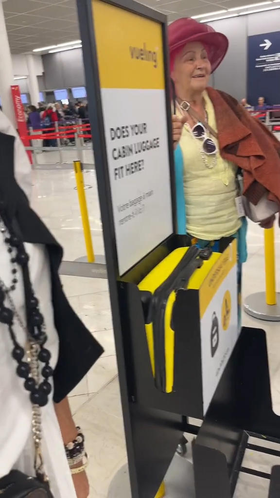 Her Carry On Bag Wasn t Quite Fitting Into The Size Tester Thingy But Her Carry On Bag Wasn t Quite Fitting Into The Size Tester Thingy But