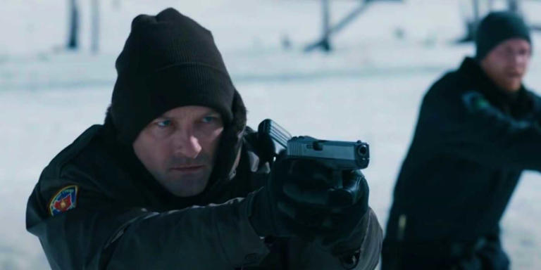 Ian Bohen as Deputy Evan pointing a pistol during the standoff in Wind River