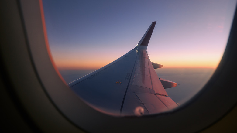 View of airplane wing through the window.
