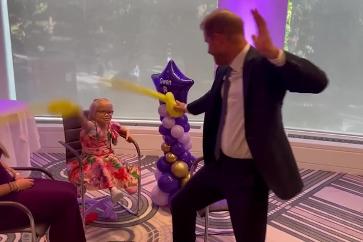 Prince Harry sword fights with young girl at WellChild Awards after she