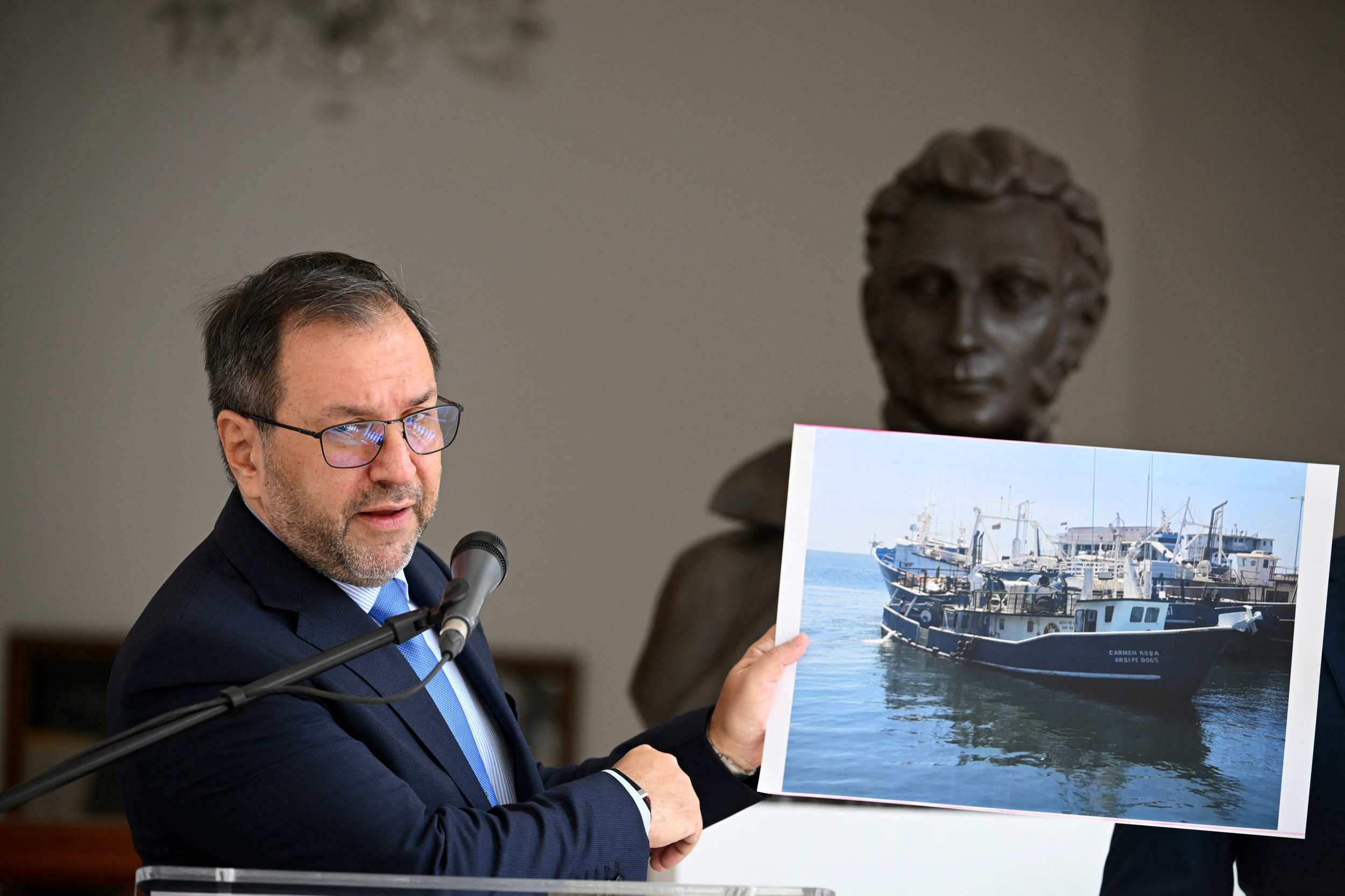 Venezuela's Foreign Minister Yvan Gil shows a picture of a fishing boat during a press conference at the Ministry of Foreign Affairs in Caracas on September 13, 2025. Federico Parra/Getty Images
