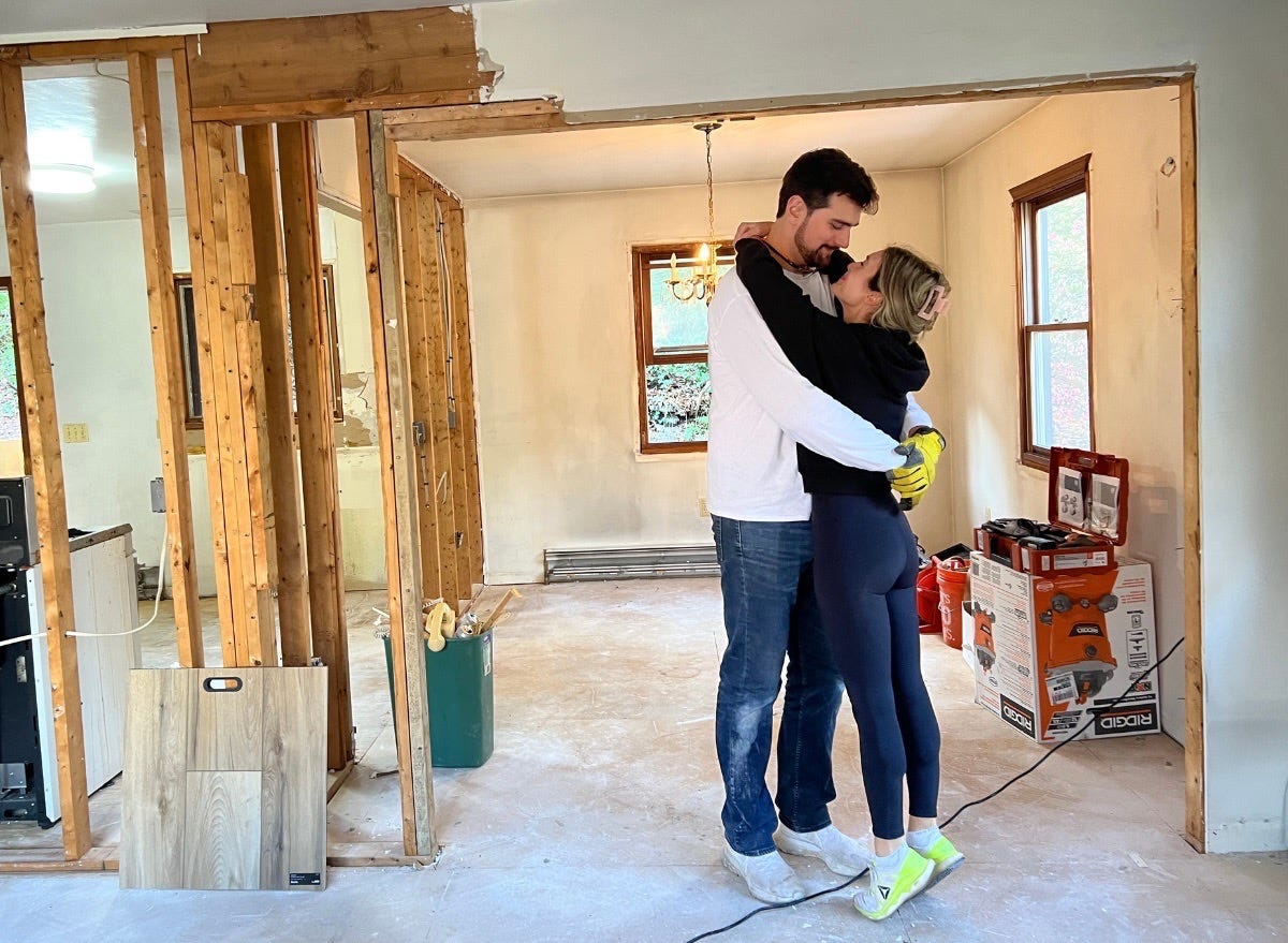 Author Alexa Mellardo and partner hugging in home that's under construction