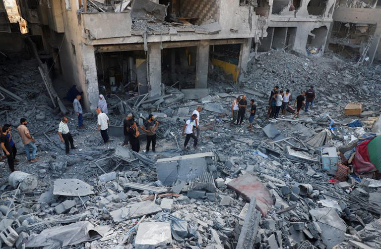 Palestinians inspect the site of an overnight Israeli strike on a house in Gaza City, September 16, 2025. REUTERS/Ebrahim Hajjaj