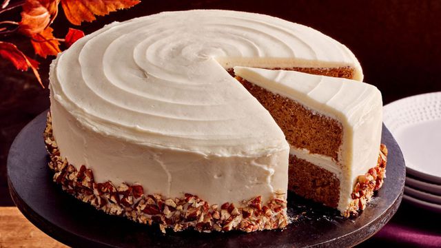 Sweet Potato Cake with Cream Cheese Frosting decorated with a sprinkle of chopped pecans on the bottom