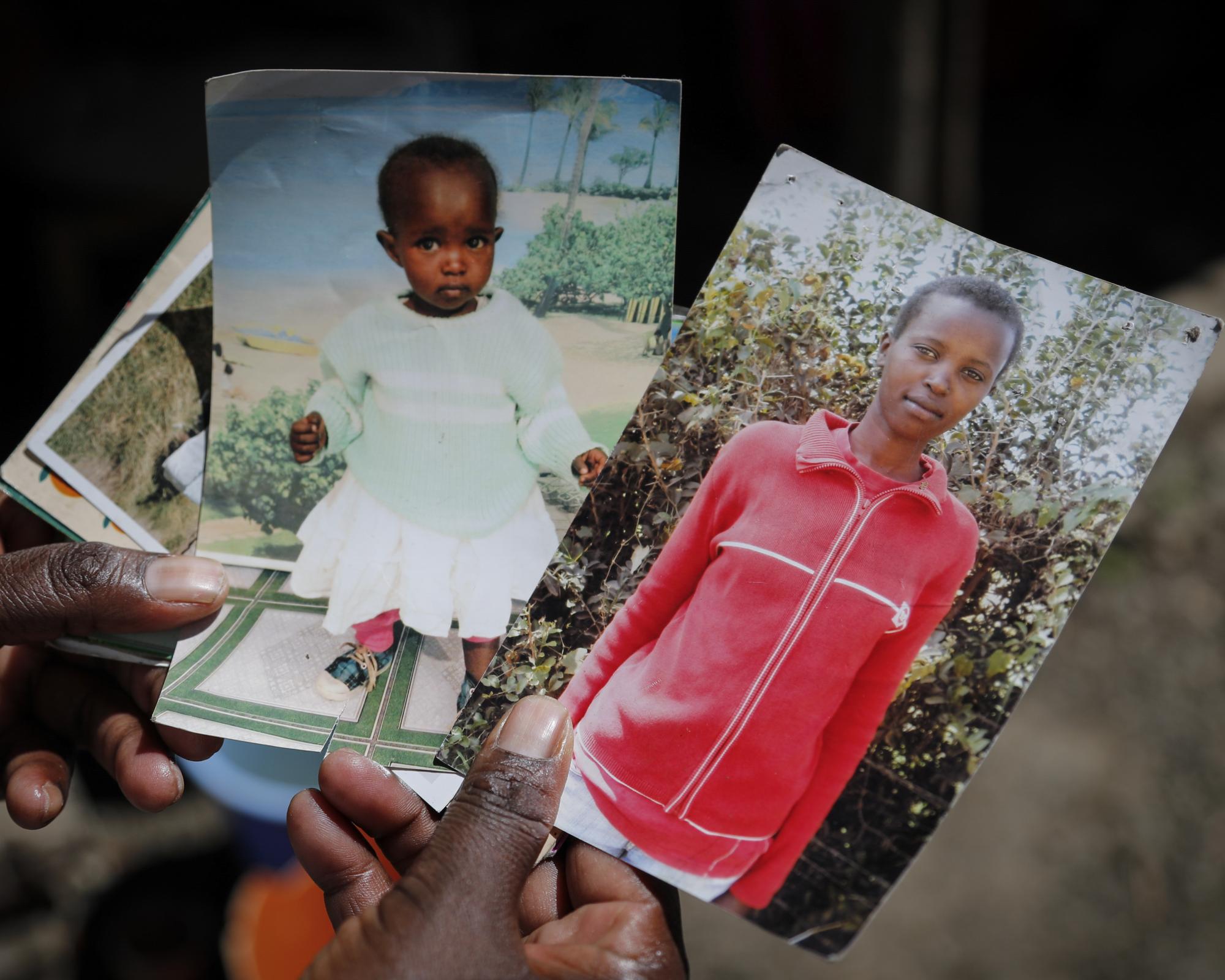 Rose Wanyua Wanjiku holding photos of her sister Agnes. Photograph: Brian Inganga/AP