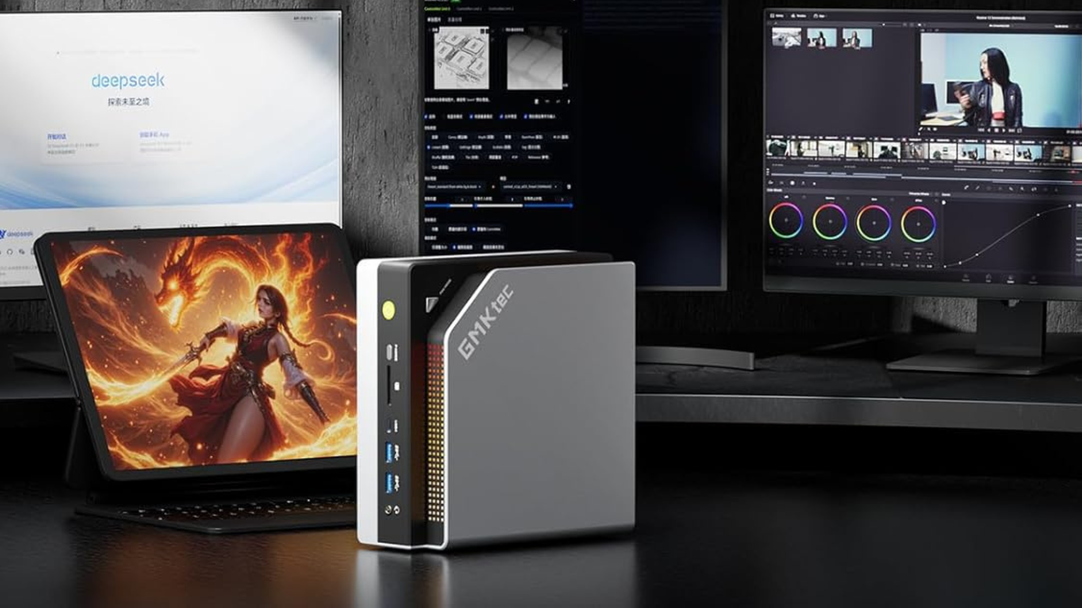 GMKtec EVO-X2 AI Mini PC next to monitors