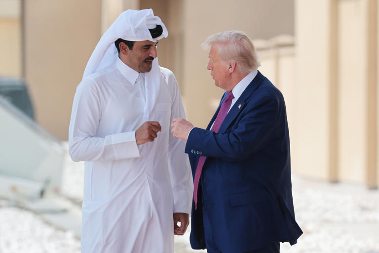 U.S. President Donald J. Trump speaks with Emir of Qatar Tamim bin Hamad al Thani as he departs the Al Udeid Air Base on May 15, 2025, in Doha, Qatar. Win McNamee/Getty Images