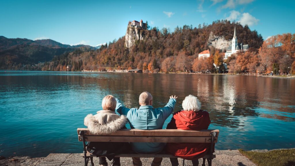 Elderly Man and Women Sitting by Bled Lake in Slovenia
