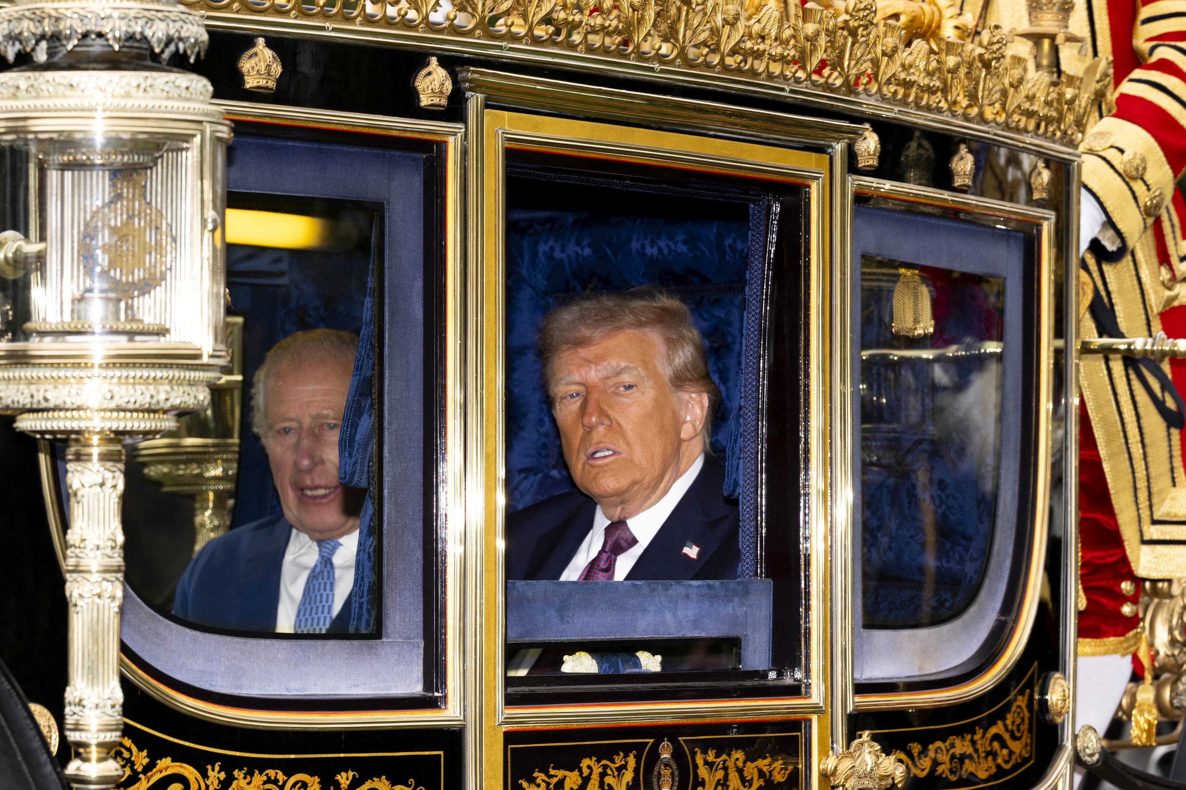 Trump was whisked away for a carriage procession during day two of his state visit. / Jordan Pettitt / via REUTERS