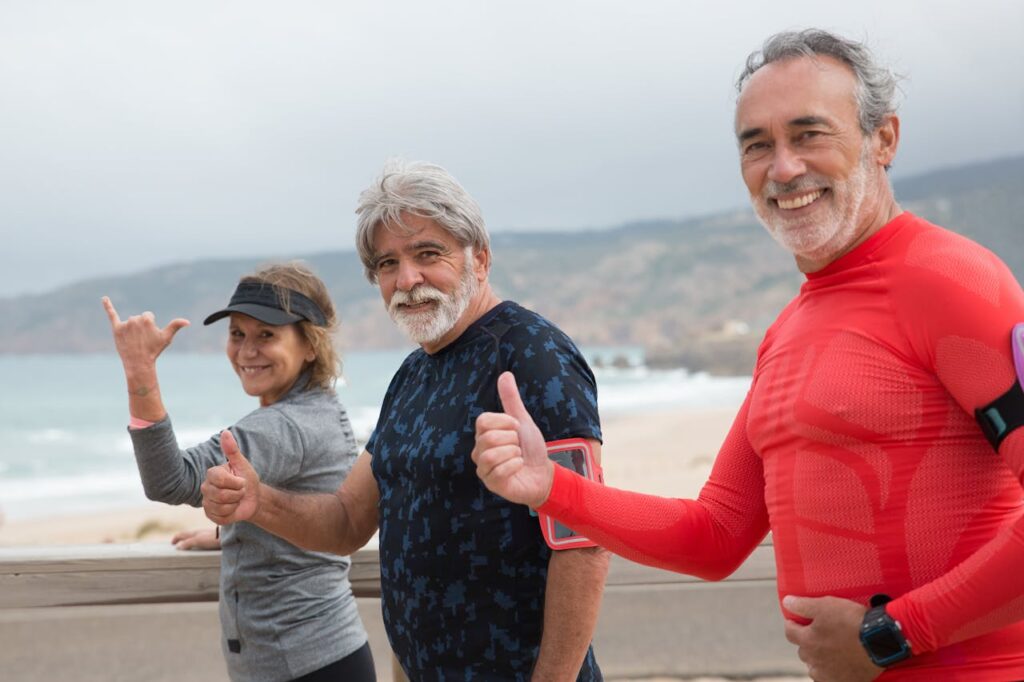 Elderly People Standing Near Each Other while Smiling at the Camera