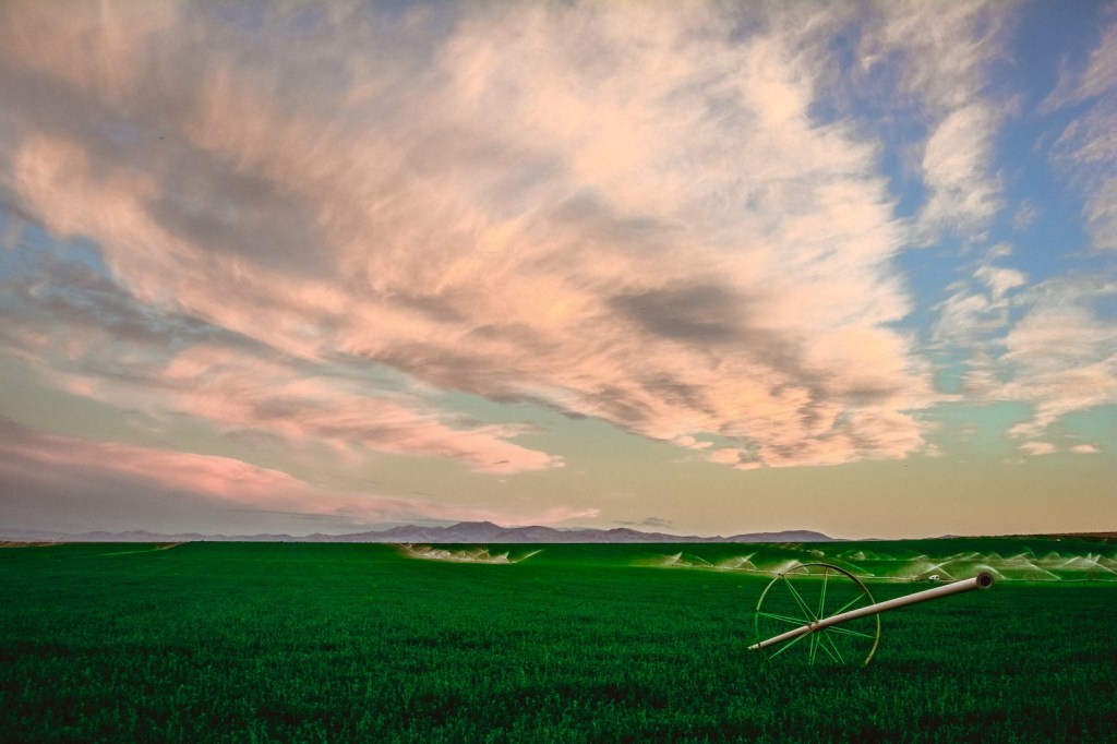 Farm land being watered on a cloudy day in Melba, Idaho.