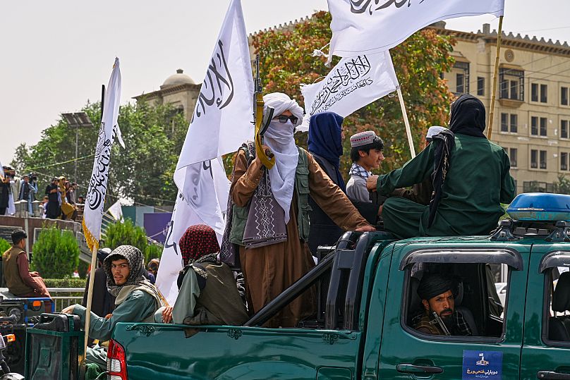 Taliban fighters and supporters ride on a pickup truck during celebrations marking the anniversary of the US withdrawal in Kabul, 15 August, 2025 AP Photo