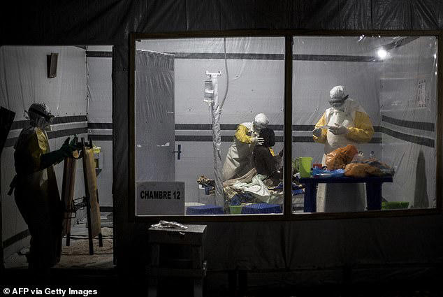 Healthcare workers treat an unidentified Ebola patient in the DRC in 2018