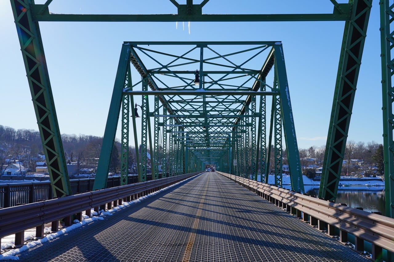 Bridge in New Hope area leading into snow-kissed village