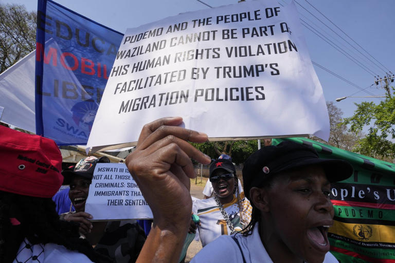 Members of Eswatin Pro-democracy activists, hold placards during their protest outside the U.S. Embassy in Pretoria, South Africa, Friday, Sept. 19, 2025. (AP Photo/Themba Hadebe)